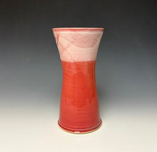 Load image into Gallery viewer, a red vase with white, foamy looking, area along the top 1/3 of the vase. The vase is pictured on a grey gradient background.