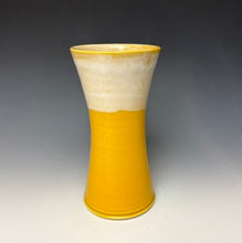 Load image into Gallery viewer, a yellow vase with light white, foamy looking, area along the top 1/3 of the vase. The vase is pictured on a grey gradient background.