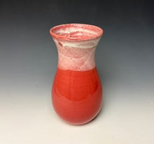Load image into Gallery viewer, a red vase with white, foamy looking, area along the top 1/3 of the vase. The vase is pictured on a grey gradient background.