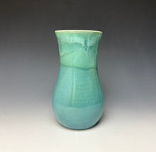 Load image into Gallery viewer, a seafoam green vase with light white, foamy looking, area along the top 1/3 of the vase. The vase is pictured on a grey gradient background.