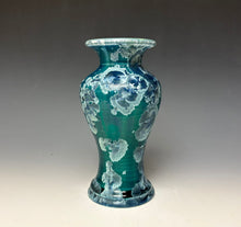 Load image into Gallery viewer, A glossy ceramic vase with a teal and turquoise body featuring silver zinc crystals, set against a dark gray to light gray gradient studio background.
