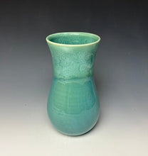 Load image into Gallery viewer, a seafoam green vase with light white, foamy looking, area along the top 1/3 of the vase. The vase is pictured on a grey gradient background.
