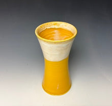 Load image into Gallery viewer, a yellow vase with light white, foamy looking, area along the top 1/3 of the vase. The vase is pictured on a grey gradient background.
