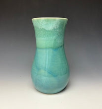 Load image into Gallery viewer, a seafoam green vase with light white, foamy looking, area along the top 1/3 of the vase. The vase is pictured on a grey gradient background.
