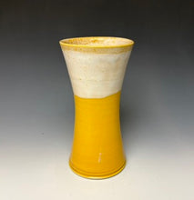 Load image into Gallery viewer, a yellow vase with light white, foamy looking, area along the top 1/3 of the vase. The vase is pictured on a grey gradient background.
