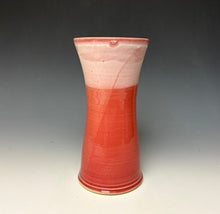 Load image into Gallery viewer, a red vase with white, foamy looking, area along the top 1/3 of the vase. The vase is pictured on a grey gradient background.
