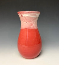 Load image into Gallery viewer, a red vase with white, foamy looking, area along the top 1/3 of the vase. The vase is pictured on a grey gradient background.
