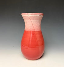 Load image into Gallery viewer, a red vase with white, foamy looking, area along the top 1/3 of the vase. The vase is pictured on a grey gradient background.
