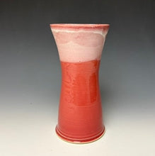 Load image into Gallery viewer, a red vase with white, foamy looking, area along the top 1/3 of the vase. The vase is pictured on a grey gradient background.
