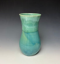 Load image into Gallery viewer, a seafoam green vase with light white, foamy looking, area along the top 1/3 of the vase. The vase is pictured on a grey gradient background.
