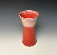 Load image into Gallery viewer, a red vase with white, foamy looking, area along the top 1/3 of the vase. The vase is pictured on a grey gradient background.
