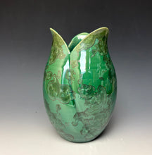 Load image into Gallery viewer, A green ceramic pitcher tulip shaped vase with a glossy finish and zinc crystals that appear as embossed floral patterns, set against a dark gray to light gray gradient background.
